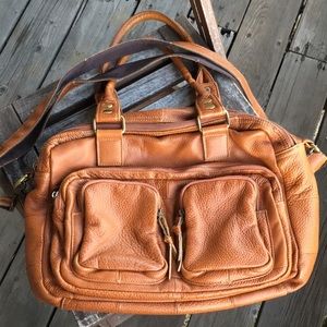 Brown leather bag with brass hardware